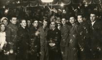 Izsak Brull surrounded by employees